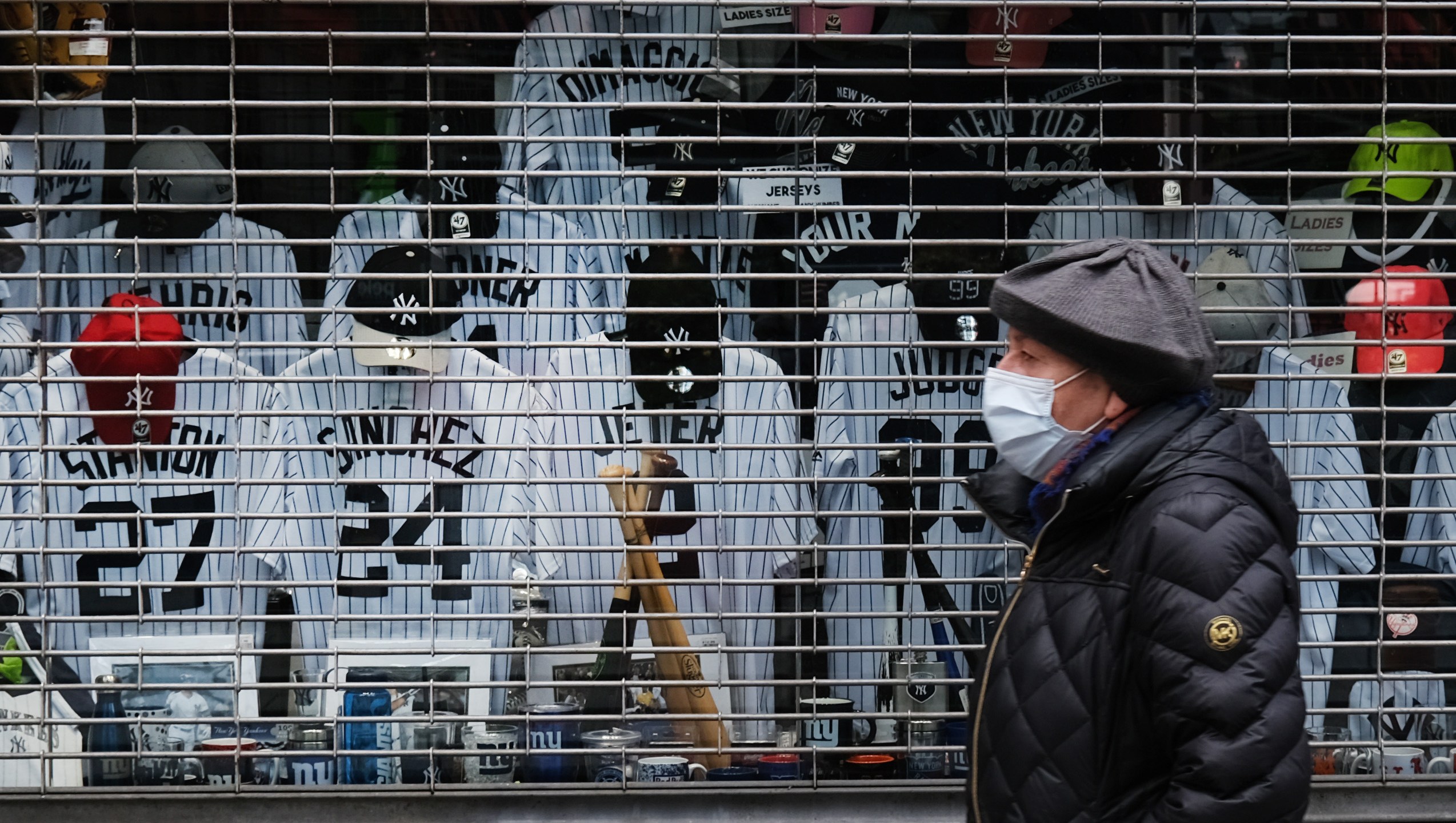 Jerseys of famous New York Yankees baseball players are displayed in the window of a shuttered business as the coronavirus keeps businesses mostly closed on April 20, 2020, in New York City. (Credit: by Spencer Platt / Getty Images)