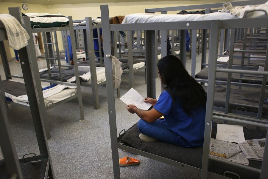 An immigration detainee from Bangladesh reads through his case papers while on his bunk at the Immigration and Customs Enforcement (ICE), detention facility on February 28, 2013 in Florence, Arizona. (John Moore/Getty Images)