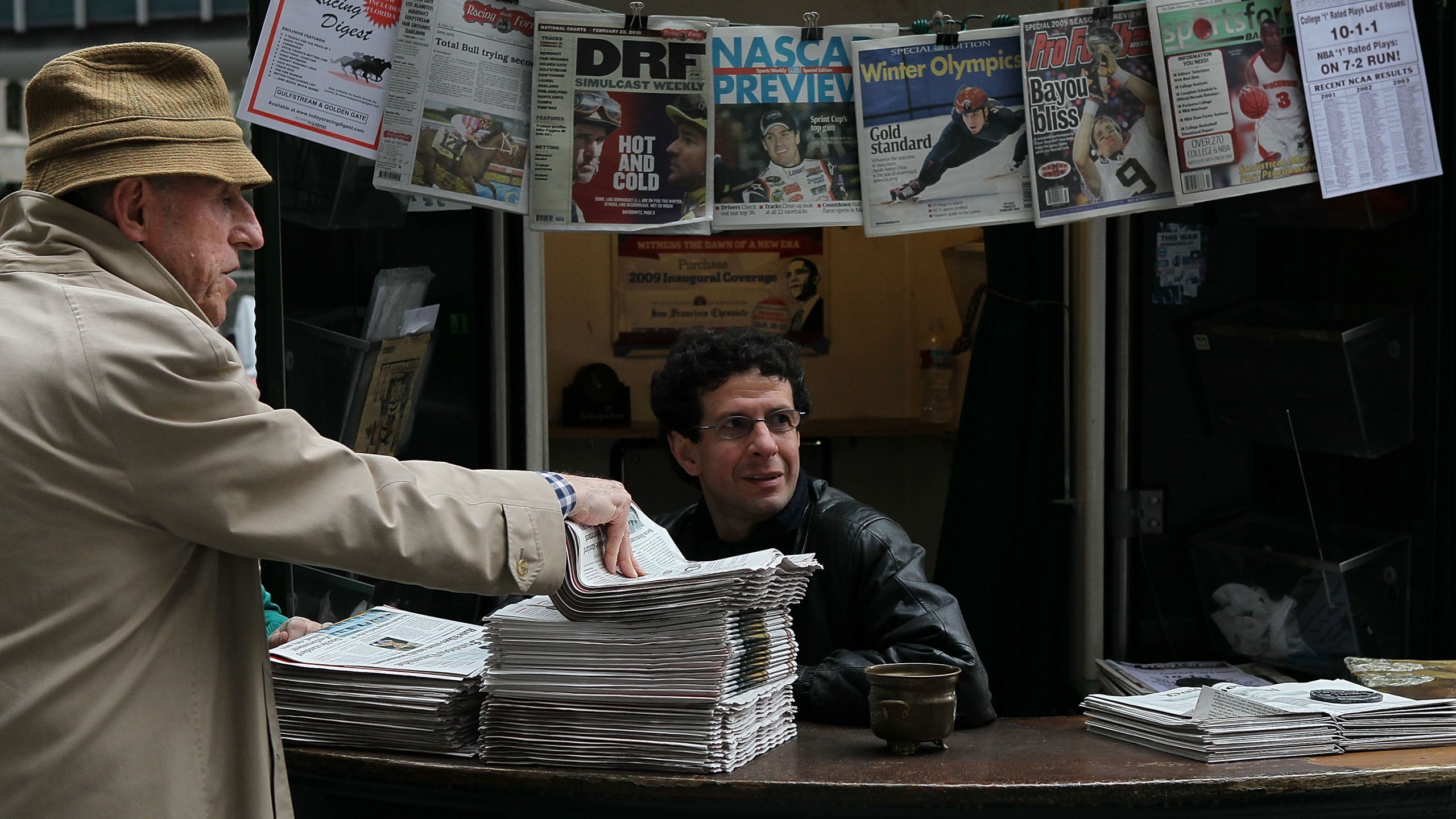 A customer buys a copy of the San Francisco Chronicle from Karim Benkanoun (R) at Nick's Newsstand February 26, 2010 in San Francisco, California. (Justin Sullivan/Getty Images)