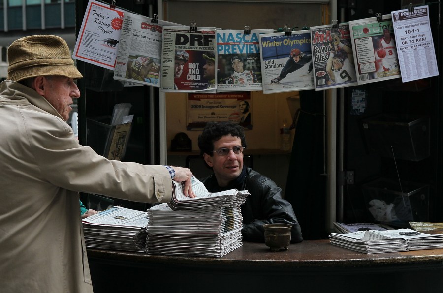 A customer buys a copy of the San Francisco Chronicle from Karim Benkanoun (R) at Nick's Newsstand February 26, 2010 in San Francisco, California. (Justin Sullivan/Getty Images)