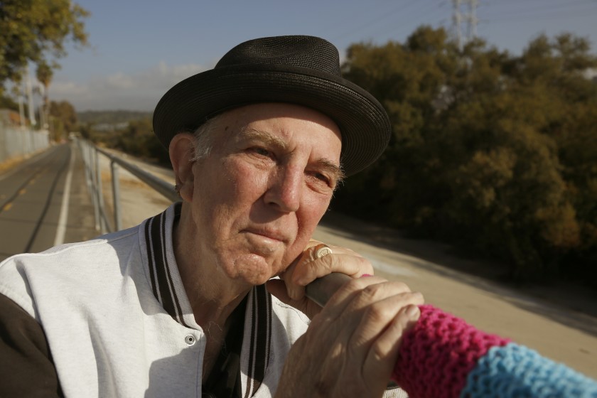 Lewis MacAdams leans on a railing along a green stretch of the Los Angeles River in Elysian Valley, a few miles north of downtown Los Angeles, in 2016. (Mark Boster / Los Angeles Times)