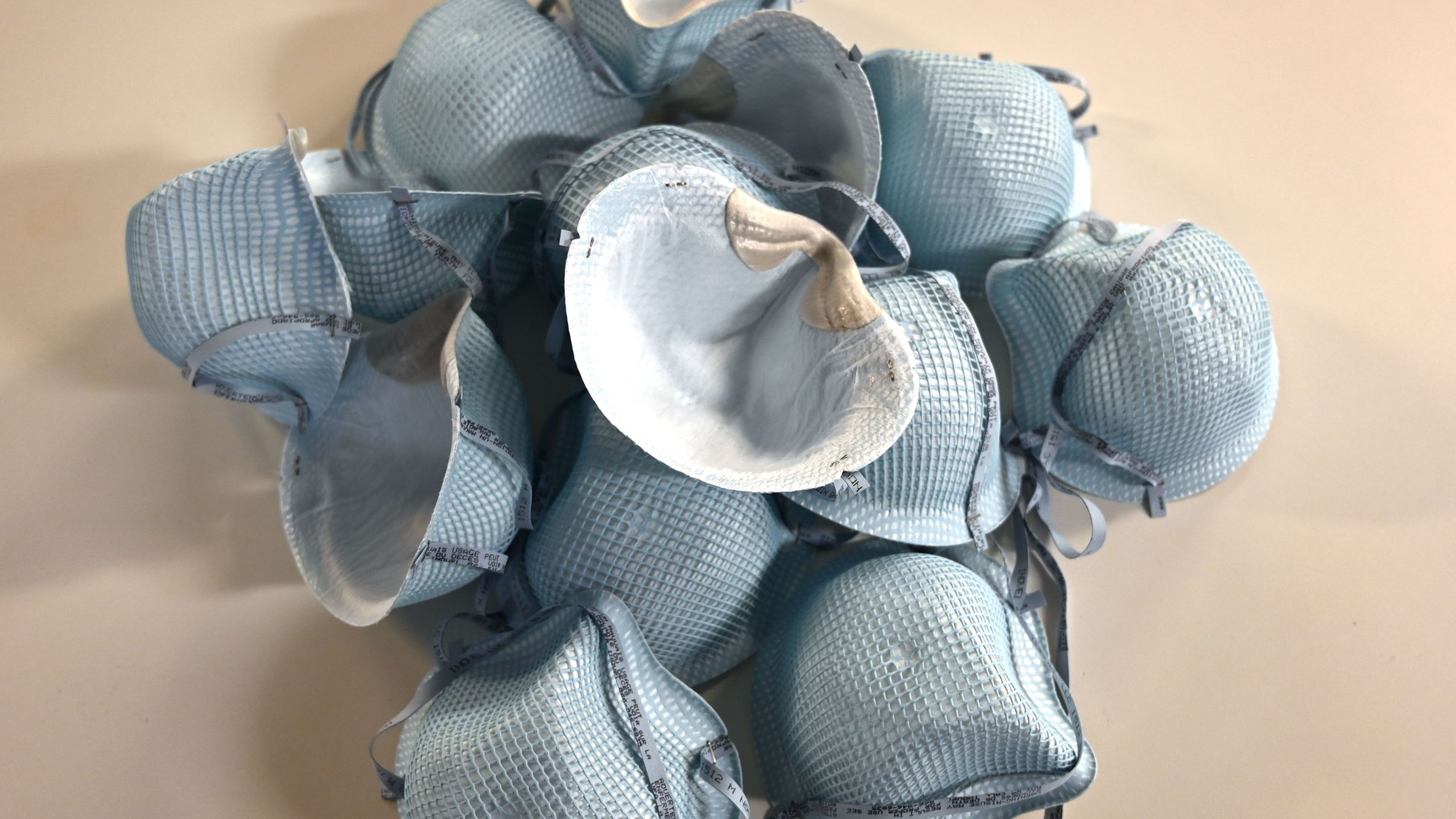 In this illustration dated Feb. 26, 2020, protective N95 face masks lie on a table at an office in Washington, DC. (Credit: EVA HAMBACH / AFP / Getty Images)