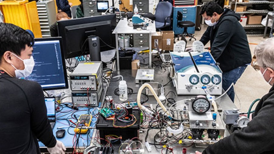 A handful of the dozens of engineers who took part in designing and building a new venitlator prototype to aid in the fight against COVID-19 work on their project in this undated photo provided by NASA/JPL.