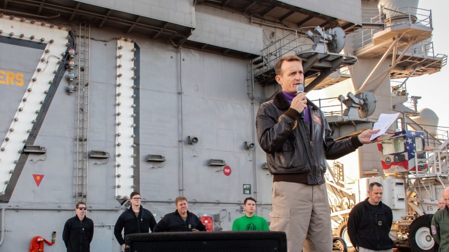 In this handout released by the U.S. Navy, Capt. Brett Crozier, commanding officer of the aircraft carrier USS Theodore Roosevelt (CVN 71), gives remarks during an all-hands call on the ships flight deck Dec. 15, 2019. (U.S. Navy via Getty Images)