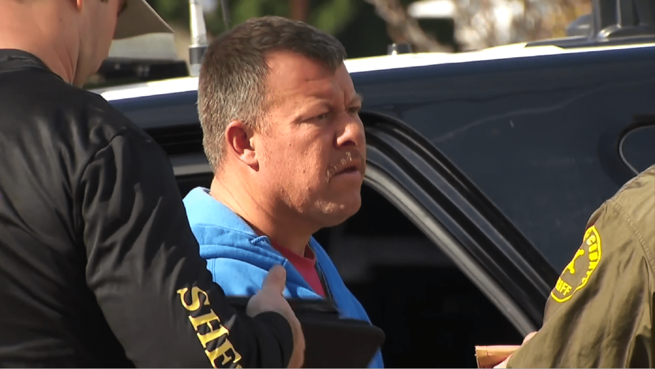 Paul Flores is questioned by authorities outside his San Pedro home as investigators searched the residence on Feb. 5, 2020. (KTLA)