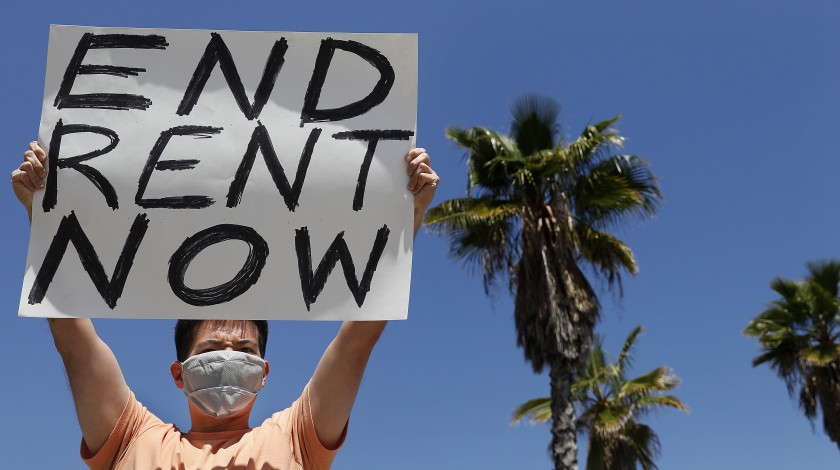 A protesters demands rent forgiveness for the month of April due to the coronavirus pandemic’s economic fallout. (Los Angeles Times)