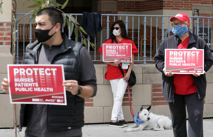 Nurses hold a rally at UCLA Medical Center and Orthopaedic Hospital on Monday in Santa Monica to draw attention to their need for more personal protective equipment and other issues.(Myung J. Chun / Los Angeles Times)