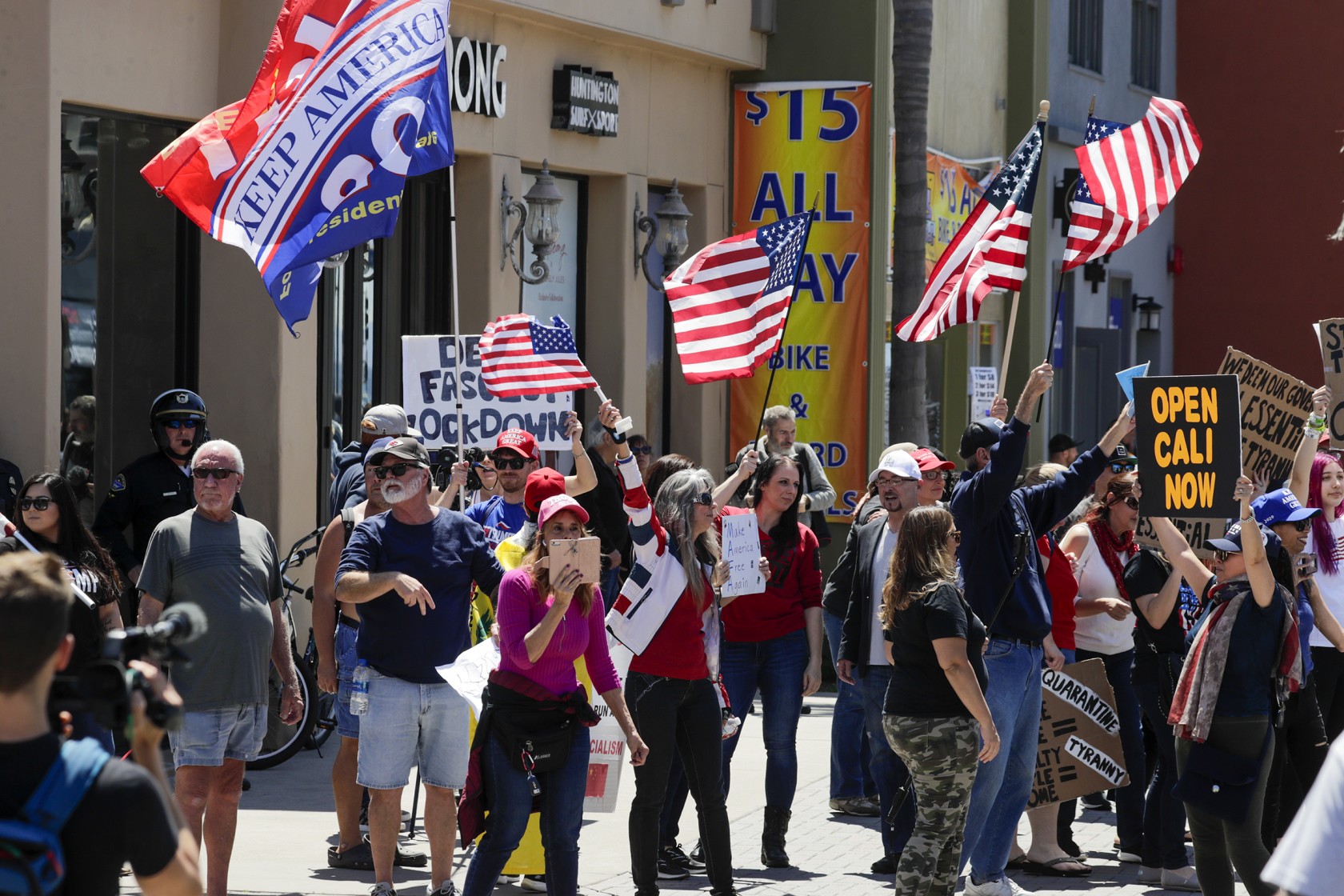 People pushing for the reopening of California businesses amid the coronavirus pandemic rally on Main Street in Huntington Beach on April 17, 2020. (Irfan Khan/Los Angeles Times)