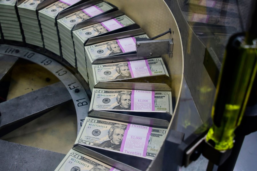 Packs of freshly printed 20 USD notes are processed for bundling and packaging at the US Treasury's Bureau of Engraving and Printing in Washington, DC July 20, 2018. (EVA HAMBACH/AFP via Getty Images)