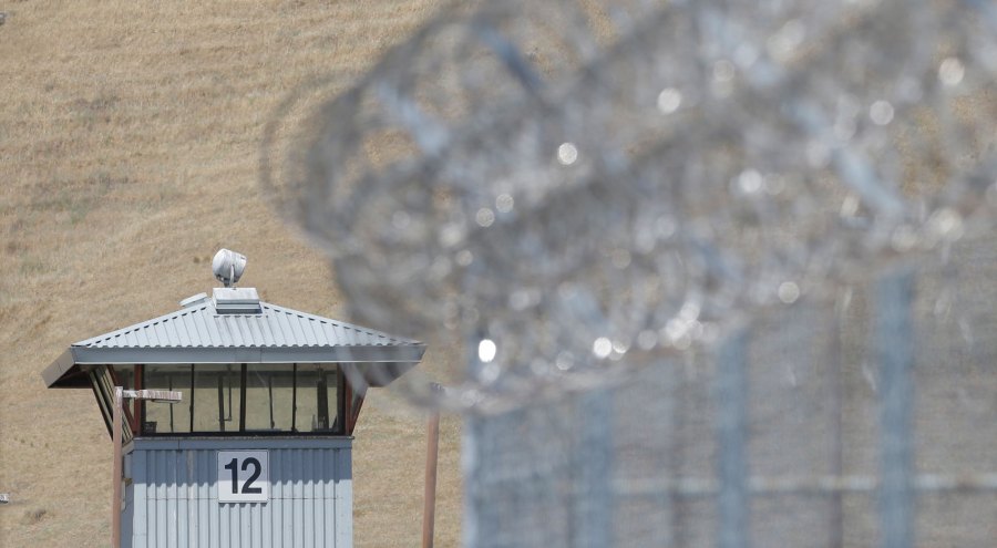 In this photo taken Wednesday May 20, 2015, a guard tower and razor wire are seen at California State Prison, Solano in Vacaville, Calif. Authorities are investigating the murder of Nicholas Anthony Rodriguez a the prison in May. An autopsy report reveals that Rodriguez' body was cut apart and most of his major body organs removed, prompting an investigation of whether a riot by dozens of prisoners was used to cover up the homicide.(AP Photo/Rich Pedroncelli)