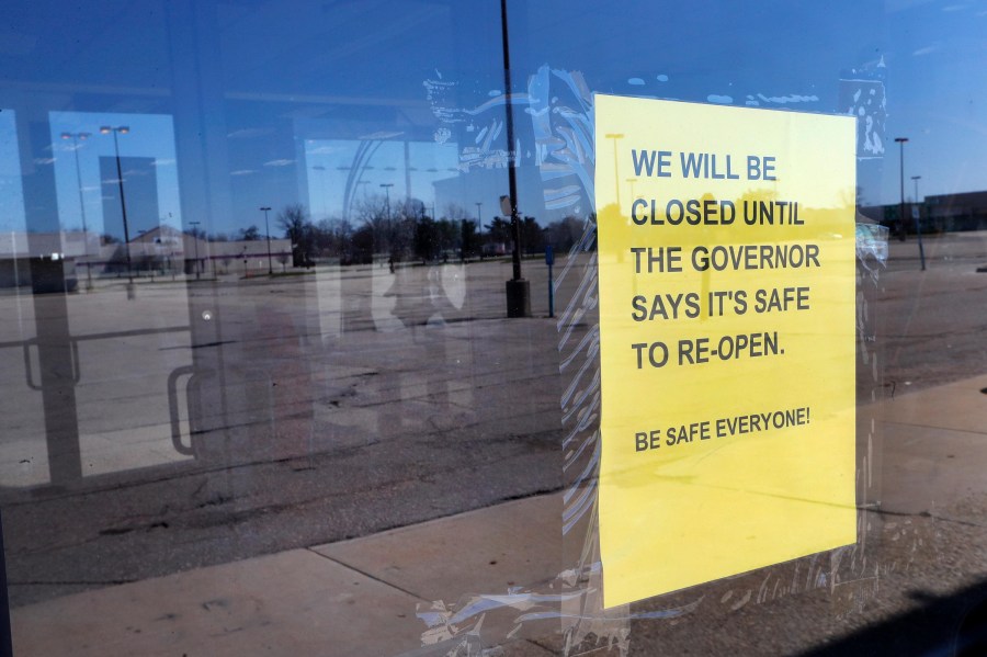 A closed sign is shown with an empty parking lot in Detroit, Thursday, April 2, 2020. (Paul Sancya/AP)