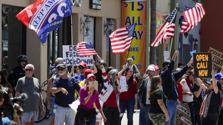 People protest in Huntington Beach against stay-at-home closures on April 17, 2020. (Los Angeles Times)