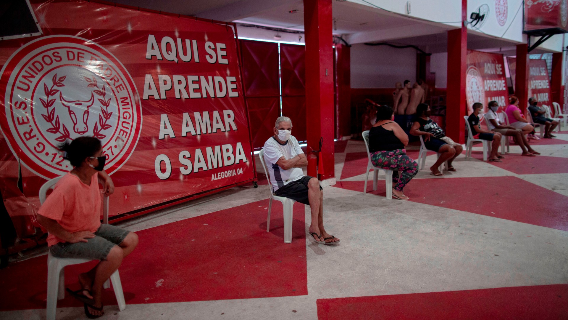 People wait to be attended by a physician during a day of free health checks for people showing symptoms of the novel coronavirus, COVID-19, at the Unidos de Padre Miguel samba school headquarters in Rio de Janeiro, Brazil, on May 24, 2020. (Mauro Puimentel/AFP/Getty Images)