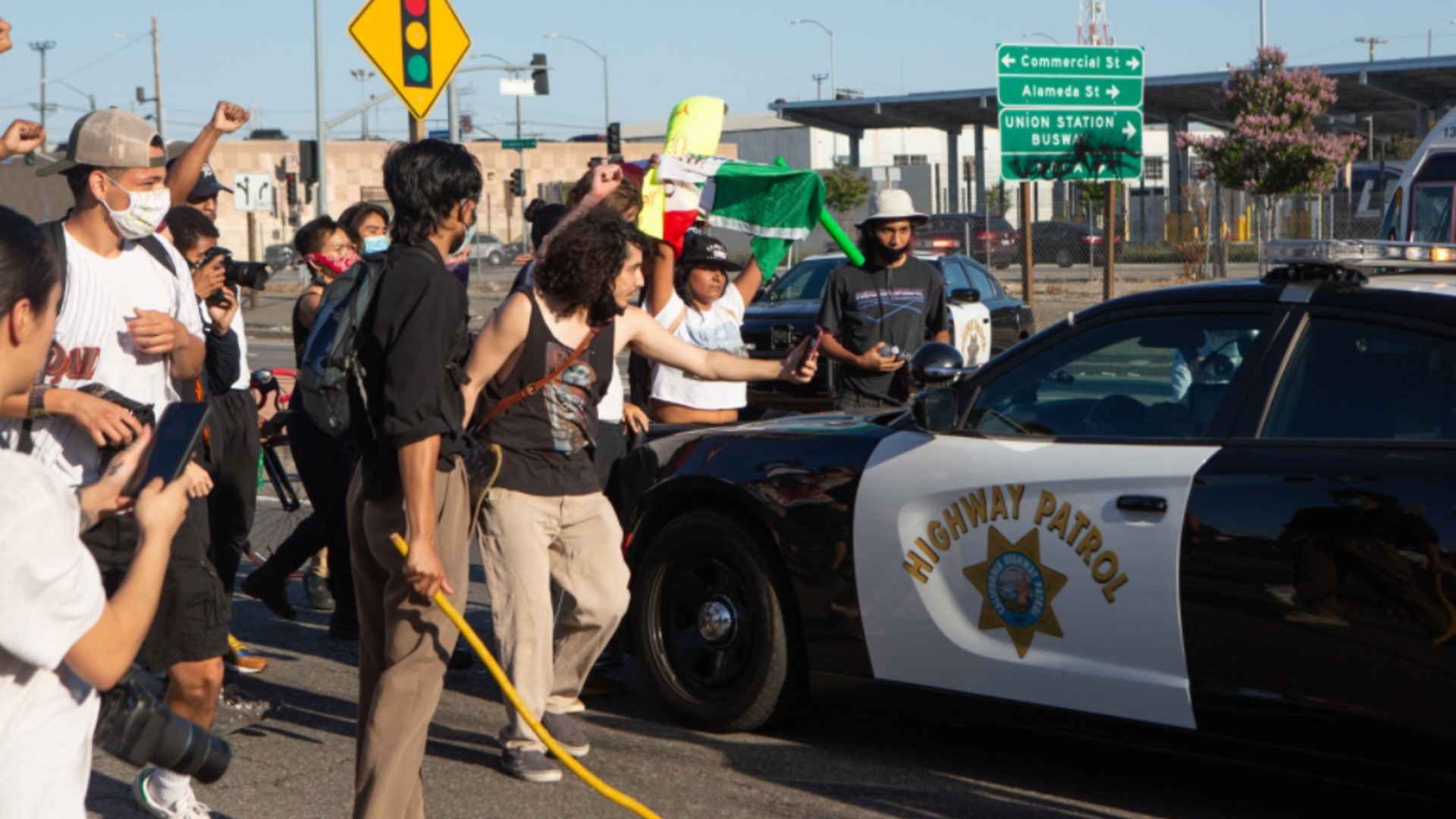 Protesters surround a CHP patrol car in downtown L.A. on May 27, 2020. (Gabriella Angotti-Jones)