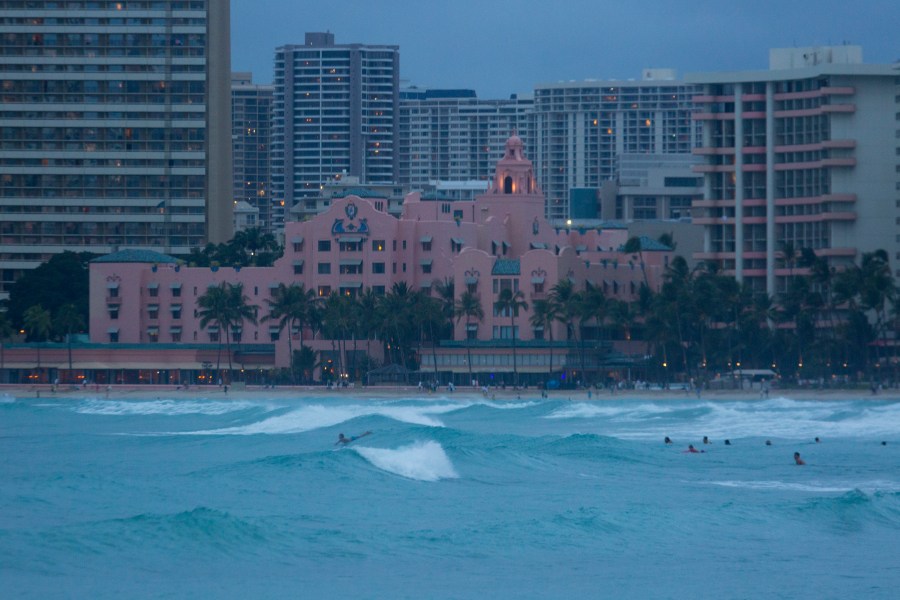 Despite warnings of dangerous rip currents and the order to stay out of the ocean, both visitors and locals continue to play in the stormy sea in front of the Royal Hawaiian Hotel brought in by Hurricane Lane as seen from the East end of Waikiki Beach on August 24, 2018. (Kat Wade/Getty Images)