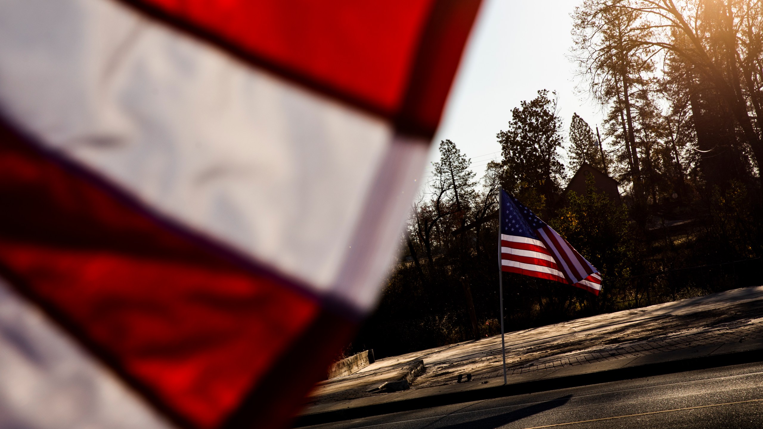 American flags flew along Skyway Road, in Paradise, California on Nov. 8, 2019 in Butte County. (Philip Pacheco/Getty Images)