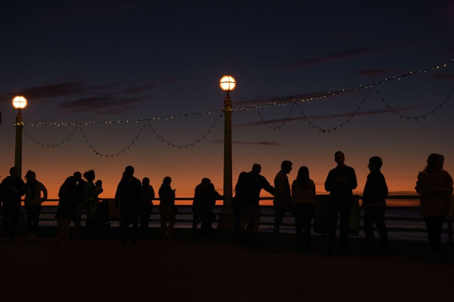 People enjoy the last sunset of the year on the pier in Manhattan Beach on Dec. 31, 2019. (Credit: Agustin Paullier / AFP / Getty Images)