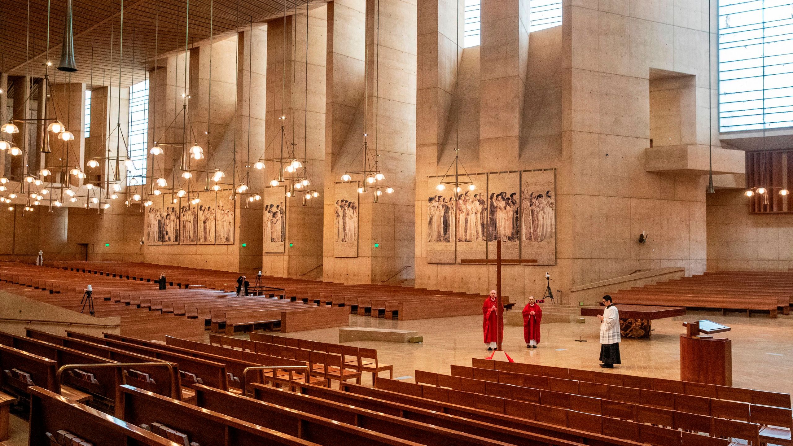 Archbishop Jose Gomez (left), Father Brian Nunez (center) and Father Raymont Medina celebrate Good Friday liturgy in an empty Cathedral of Our Lady of the Angels, April 10, 2020, in Los Angeles. (BRIAN VAN DER BRUG/POOL/AFP via Getty Images)