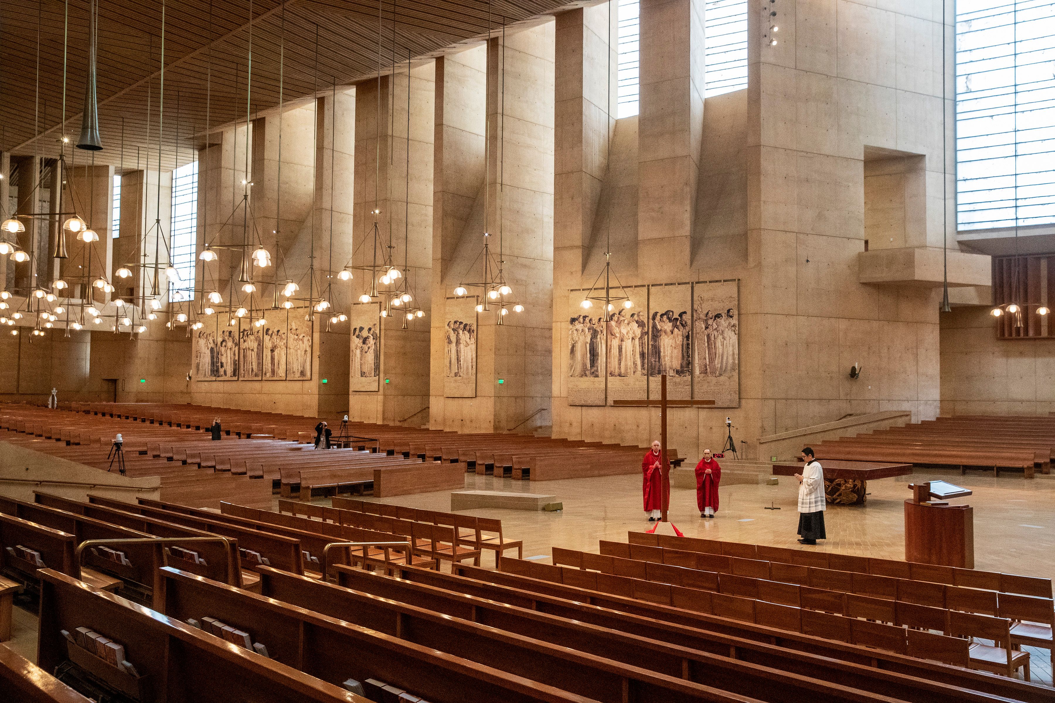 Archbishop Jose Gomez (left), Father Brian Nunez (center) and Father Raymont Medina celebrate Good Friday liturgy in an empty Cathedral of Our Lady of the Angels, April 10, 2020, in Los Angeles. (BRIAN VAN DER BRUG/POOL/AFP via Getty Images)