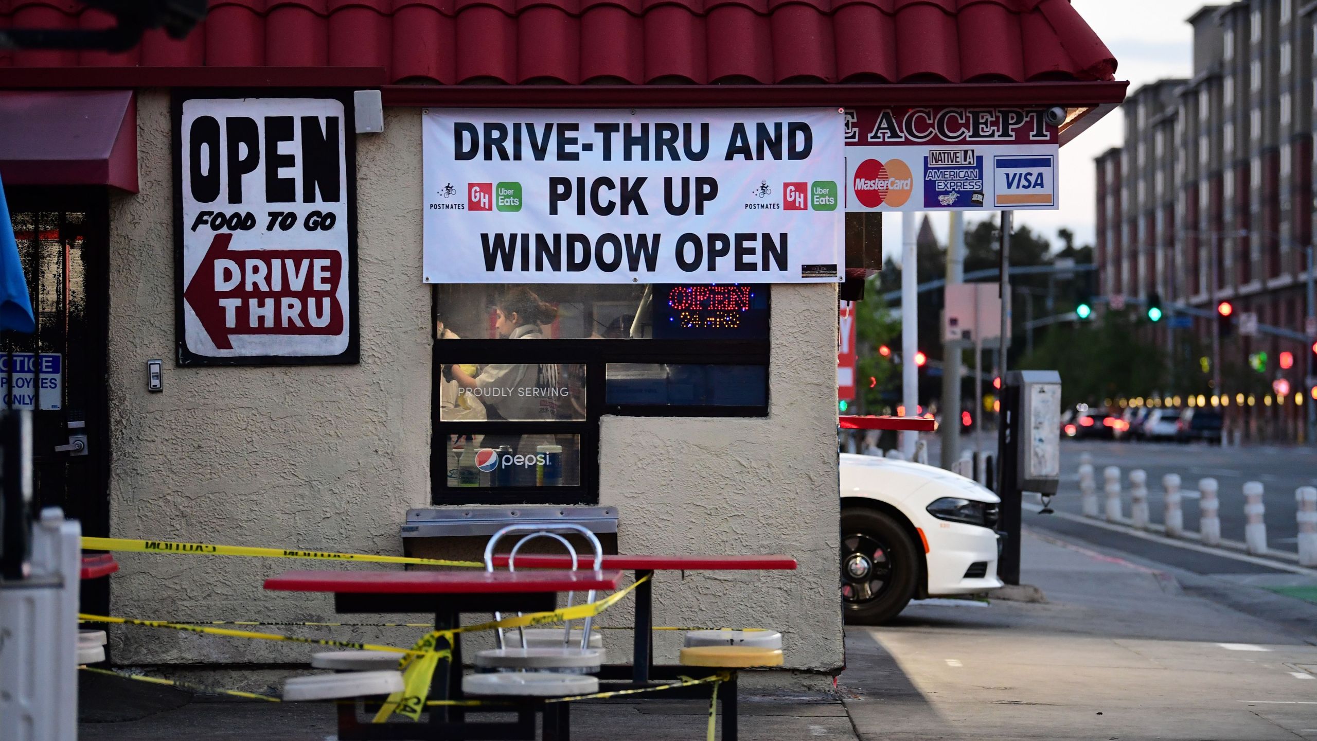 A fast food restaurant worker fills an order as a vehicle waits in the drive-thru pickup lane in Los Angeles, California on April 13, 2020 as restaurants remain open for takeout or delivery. (FREDERIC J. BROWN/AFP via Getty Images)