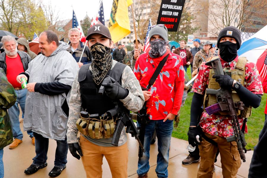 Armed protesters provide security as demonstrators take part in an "American Patriot Rally," organized on April 30, 2020, by Michigan United for Liberty on the steps of the Michigan State Capitol in Lansing, demanding the reopening of businesses. (JEFF KOWALSKY/AFP via Getty Images)