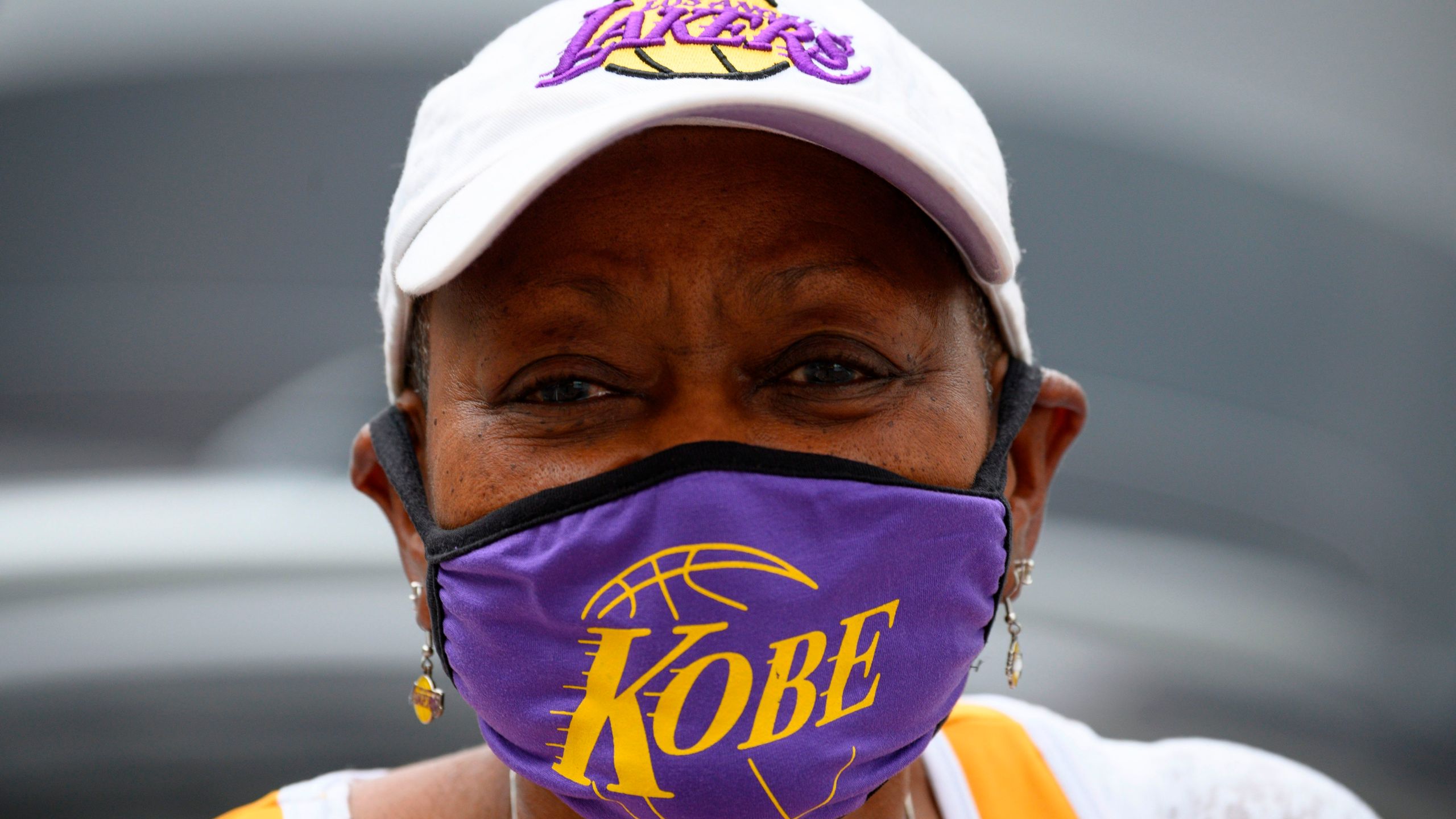 Carrie Harris Allen sells face masks, including the Kobe Bryant style she is wearing, in downtown Los Angeles on April 30, 2020. (Credit: Robyn Beck / AFP / Getty Images)