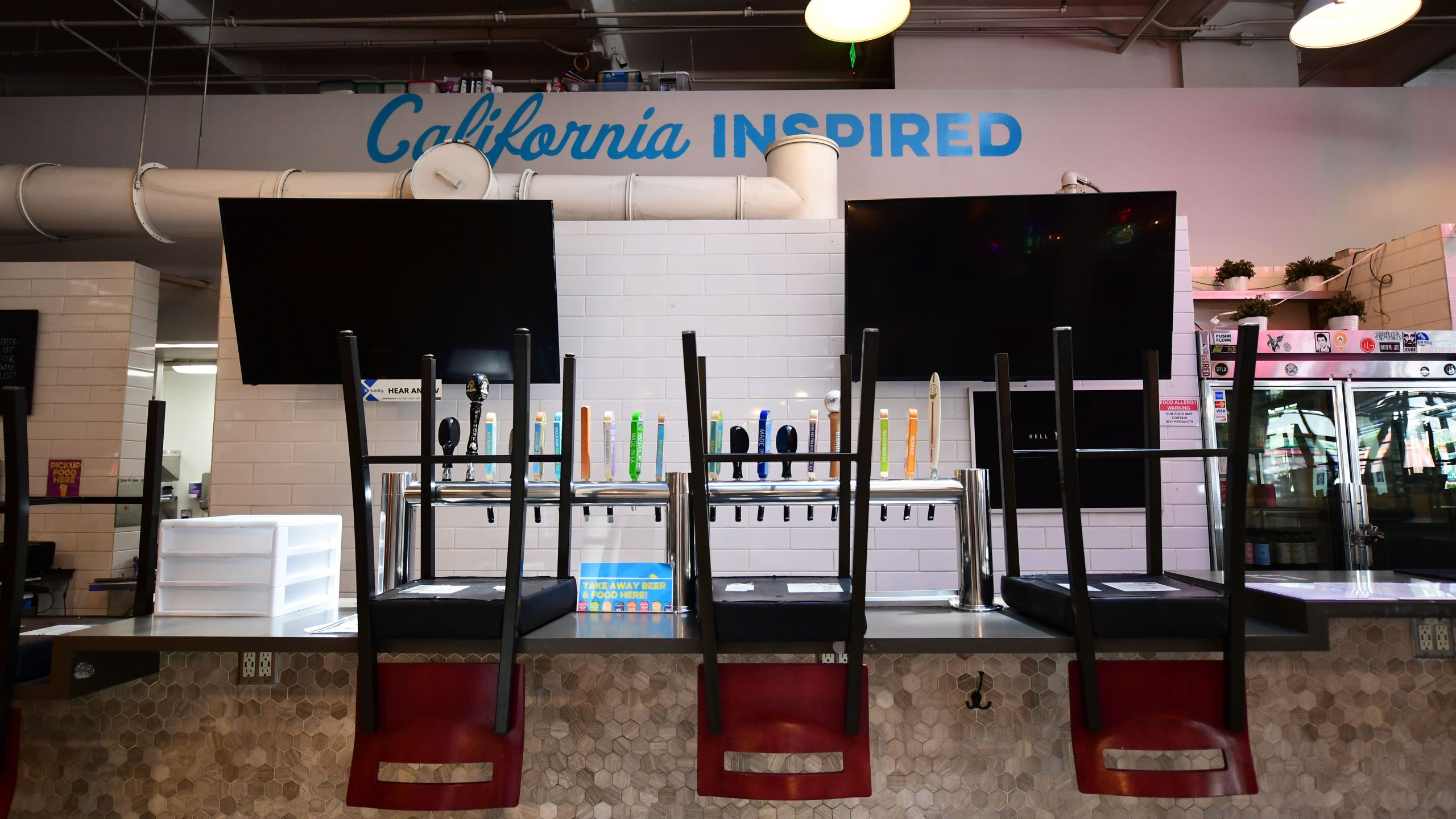 Chairs on the bar as restaurants close in what would normally be a crowded lunch time scene at the Grand Central Market in Los Angeles, California on May 4, 2020. (FREDERIC J. BROWN/AFP via Getty Images)