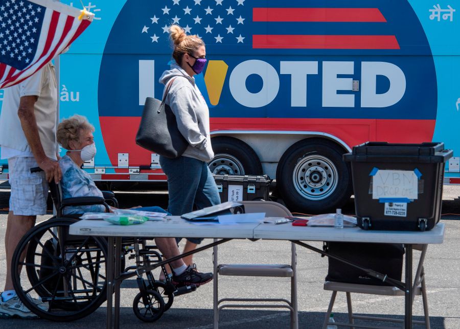 People wait to cast their votes at a polling station for the special election between Democratic state assemblywoman Christy Smith and Republican businessman and ex-Navy pilot Mike Garcia to replace former Democratic Congresswoman Katie Hill in the state's 25th Congressional District, in Santa Clarita, California on May 12, 2020. (MARK RALSTON/AFP via Getty Images)