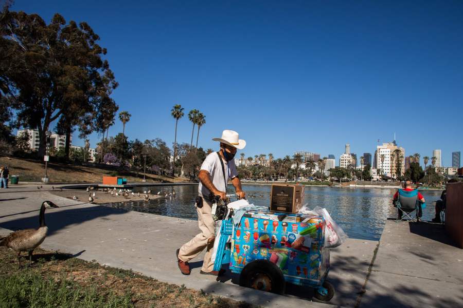 A ice-cream street vendor pushes his cart in MacArthur Park, Los Angeles on May 21, 2020. (APU GOMES/AFP via Getty Images)