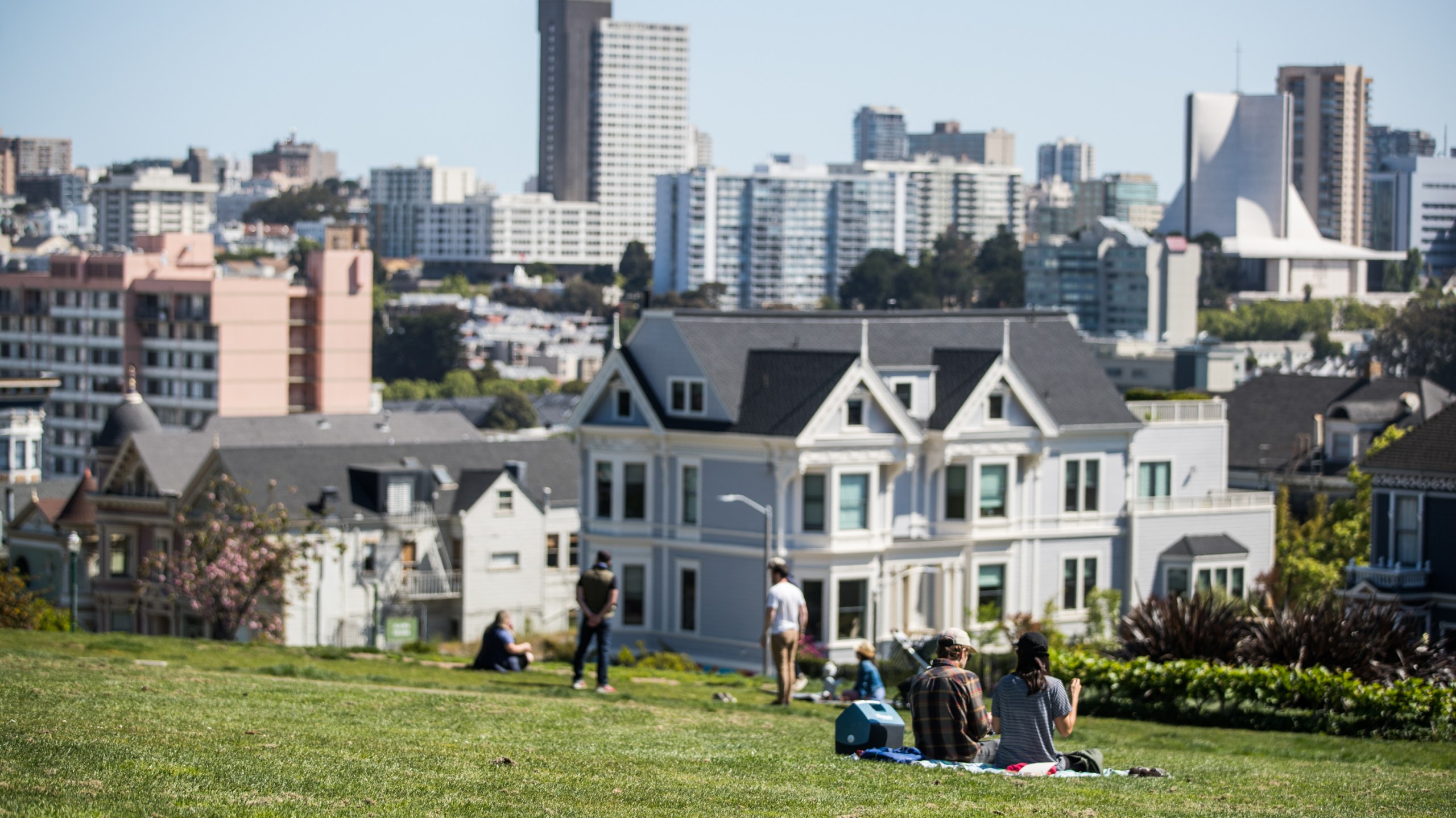 People sit on the grass at Alamo Square Park during the coronavirus pandemic on May 3, 2020 in San Francisco. (Rich Fury/Getty Images)