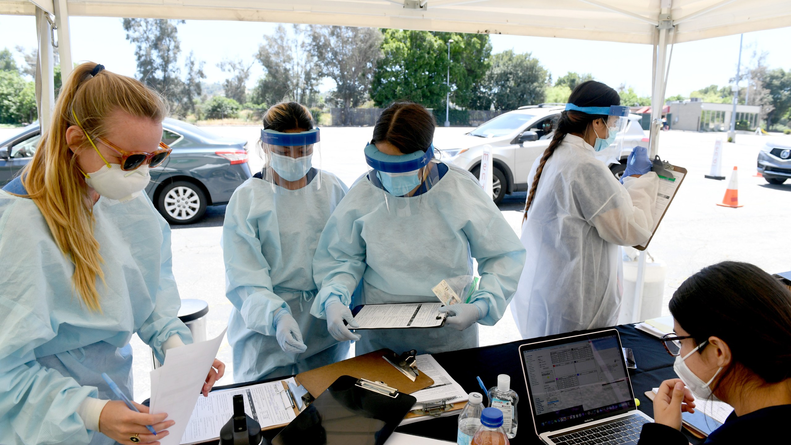 Workers perform drive-up coronavirus testing at the Westfield Fashion Square on May 13, 2020, in Sherman Oaks. (Kevin Winter/ Getty Images)