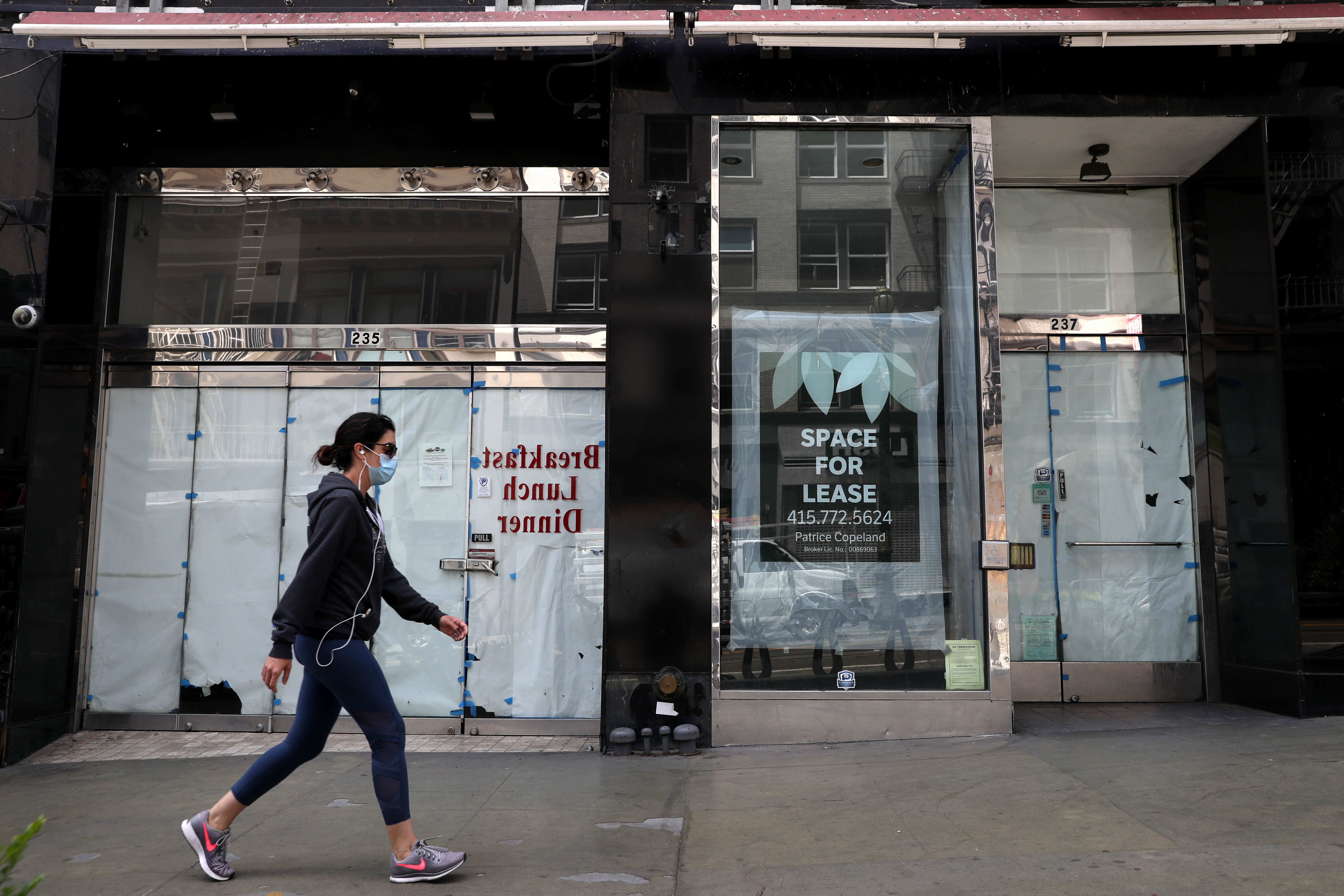 A pedestrian walks by closed stores on May 15, 2020 in San Francisco. (Justin Sullivan/Getty Images)