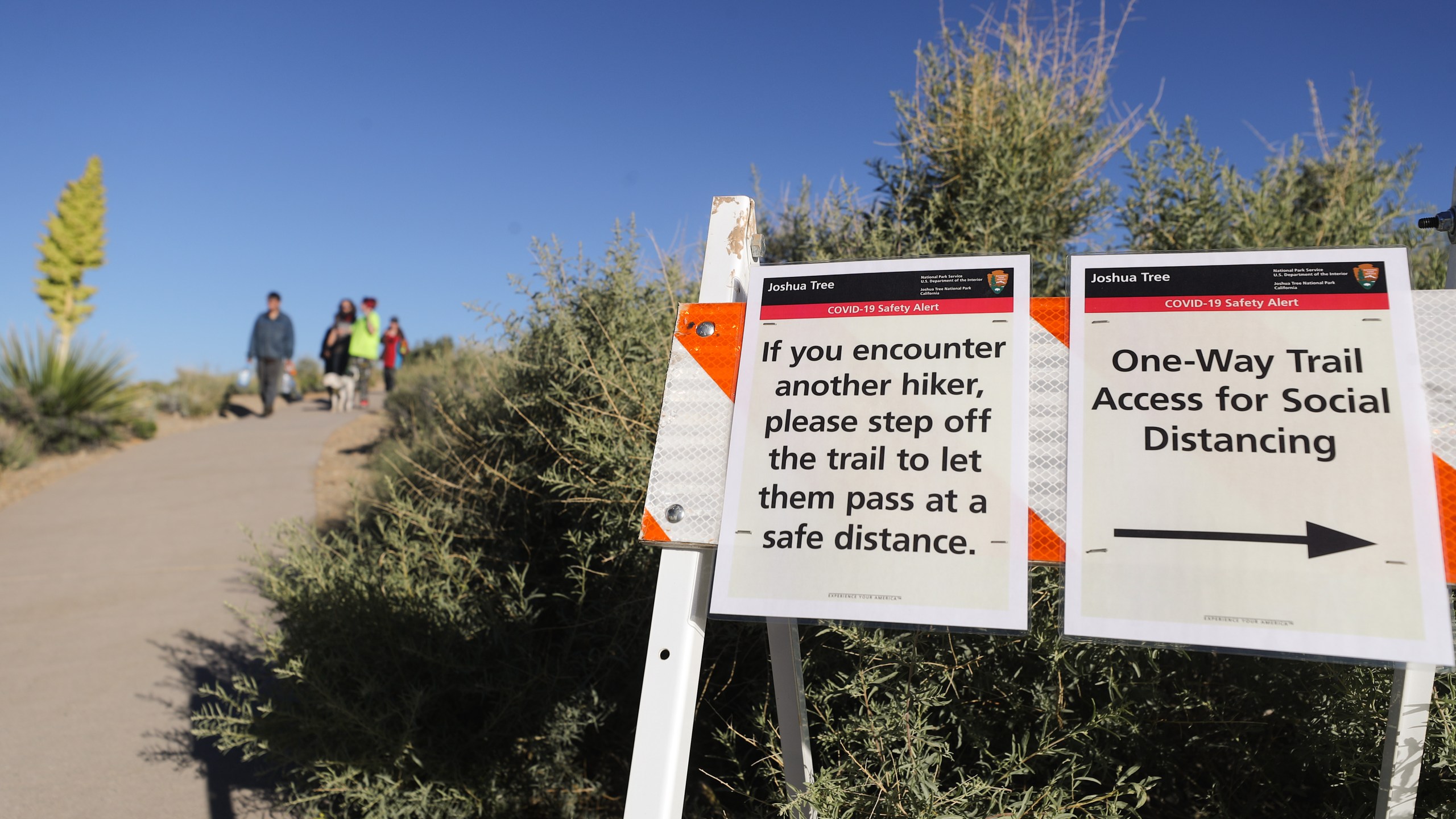 A trail is marked with social distancing signs in Joshua Tree National Park one day after the park reopened after being closed for two months due to the coronavirus pandemic on May 18, 2020, in Joshua Tree National Park, California. (Mario Tama/Getty Images)