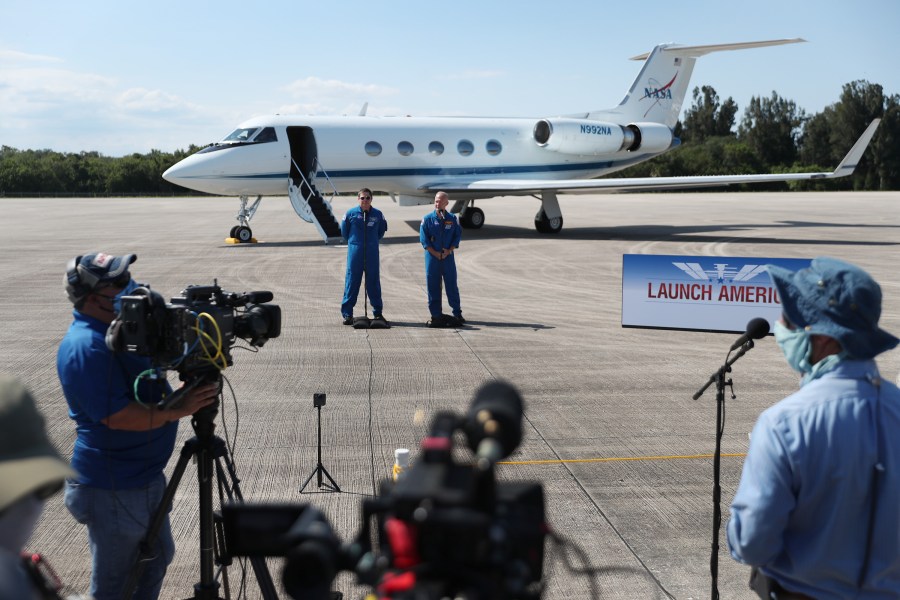 NASA astronauts Bob Behnken (L) and Doug Hurley speak to the media after arriving at the Kennedy Space Center on May 20, 2020, in Cape Canaveral, Florida. (Joe Raedle/Getty Images)