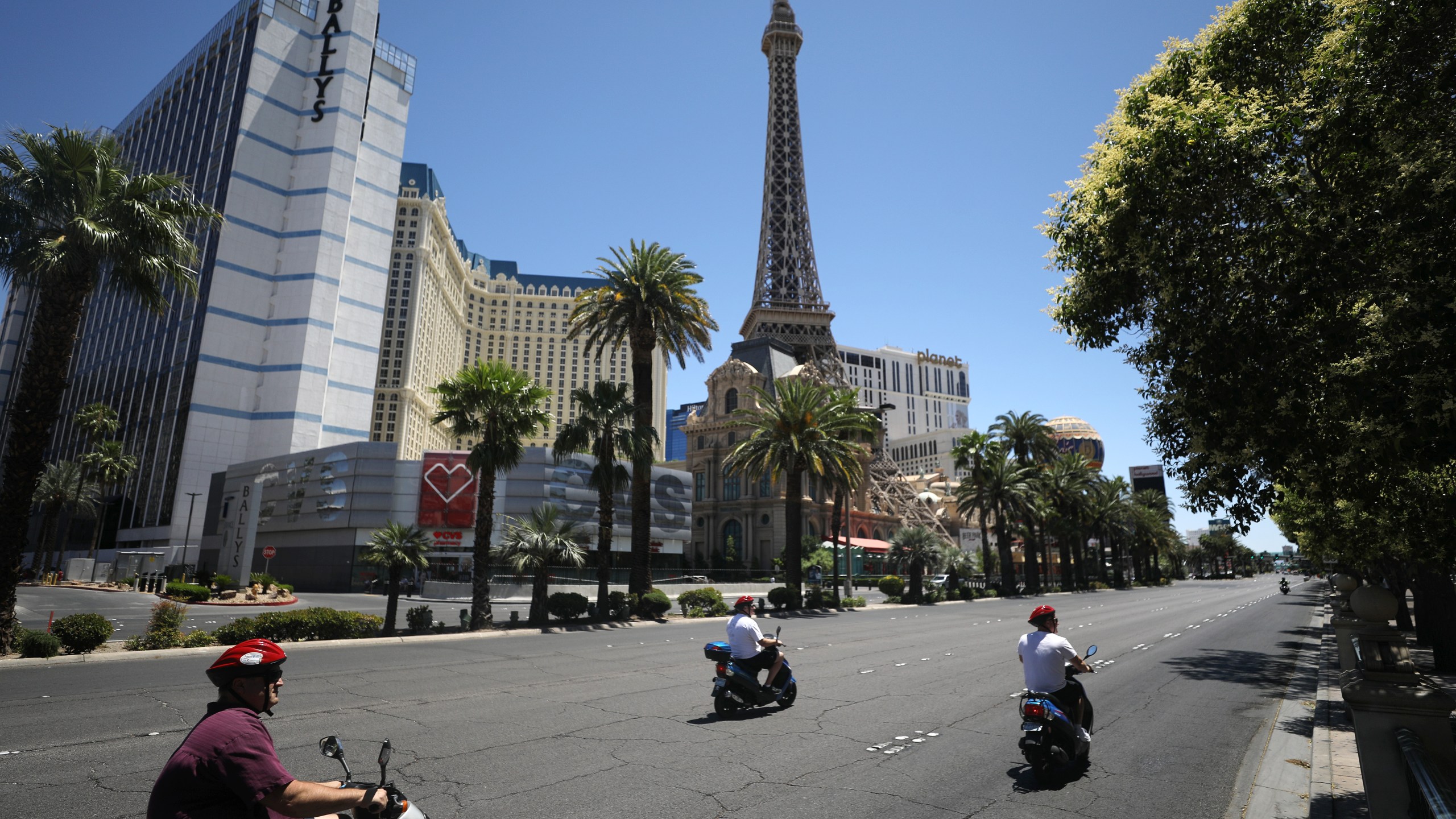 People on scooters ride on the quiet Las Vegas Strip on May 24, 2020. (Mario Tama/Getty Images)