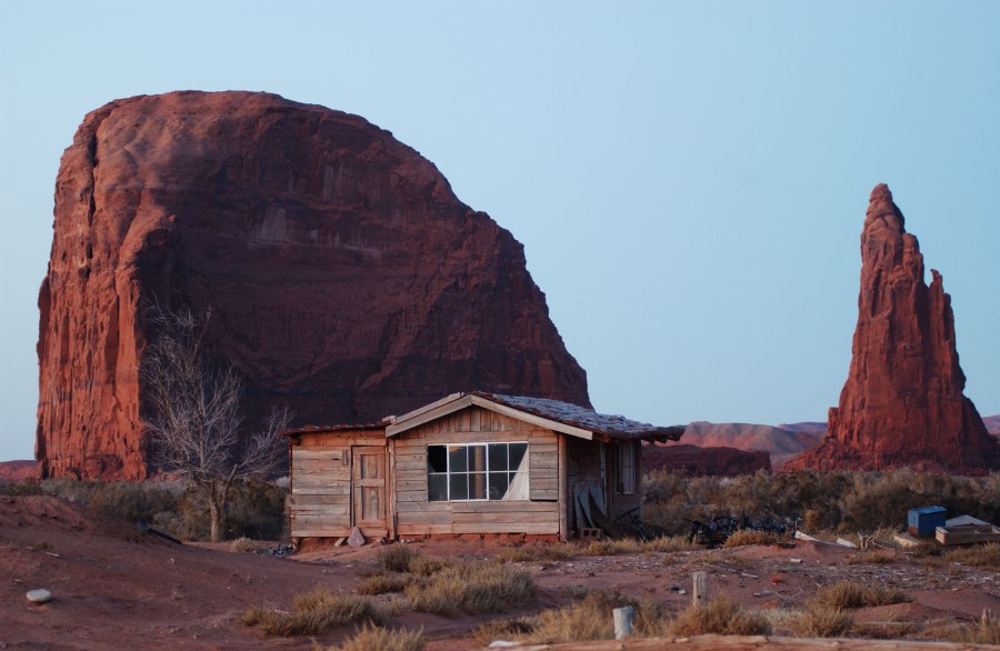 A house stands near sandstone formations south of Rock Point on the Navajo Reservation in Arizona on Dec. 5, 2002. (David McNew/Getty Images)