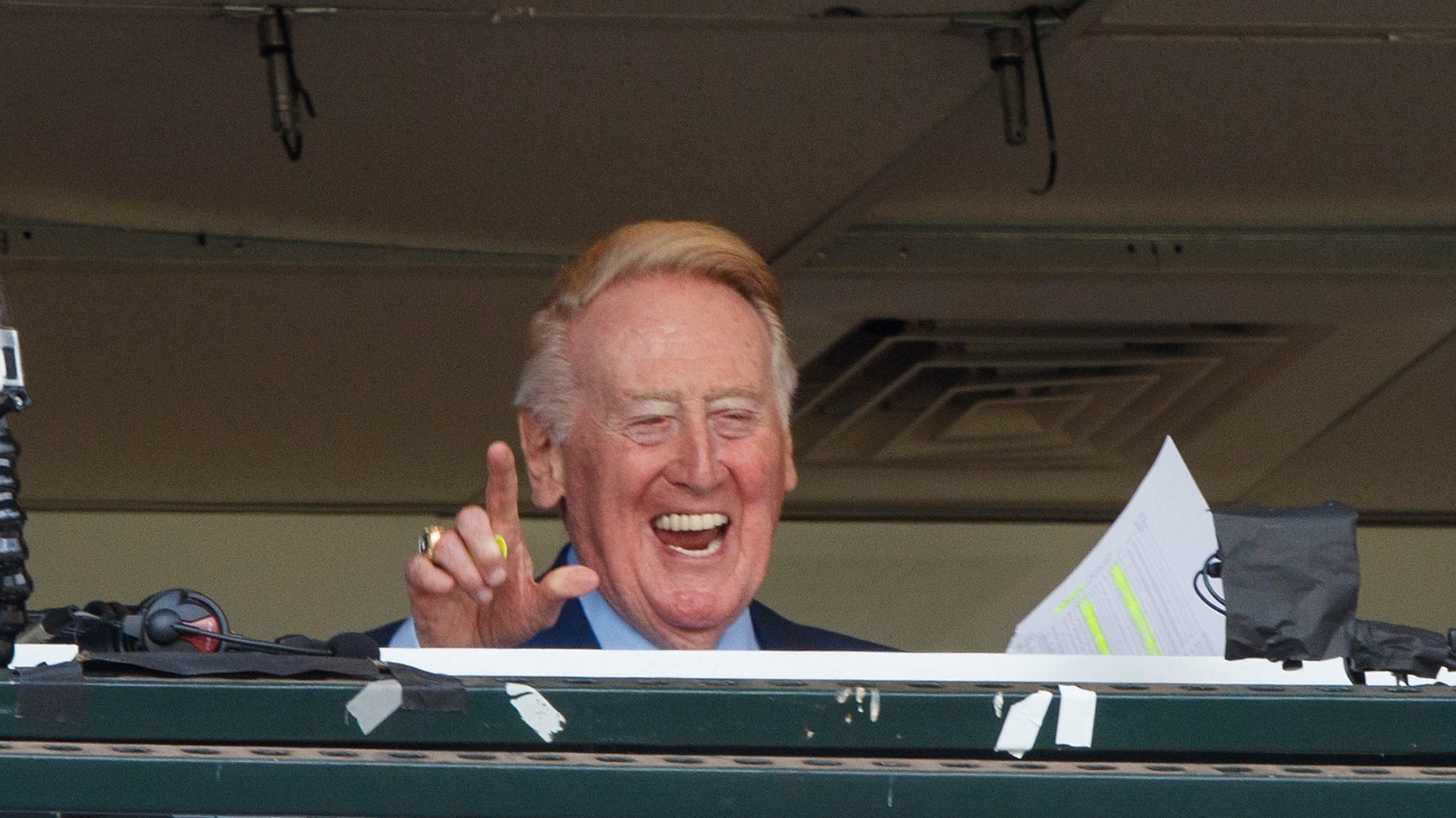 Vin Scully waves to fans in the broadcast booth before the game between the San Francisco Giants and the Los Angeles Dodgers at AT&T Park on October 2, 2016, in San Francisco. (Jason O. Watson/Getty Images)