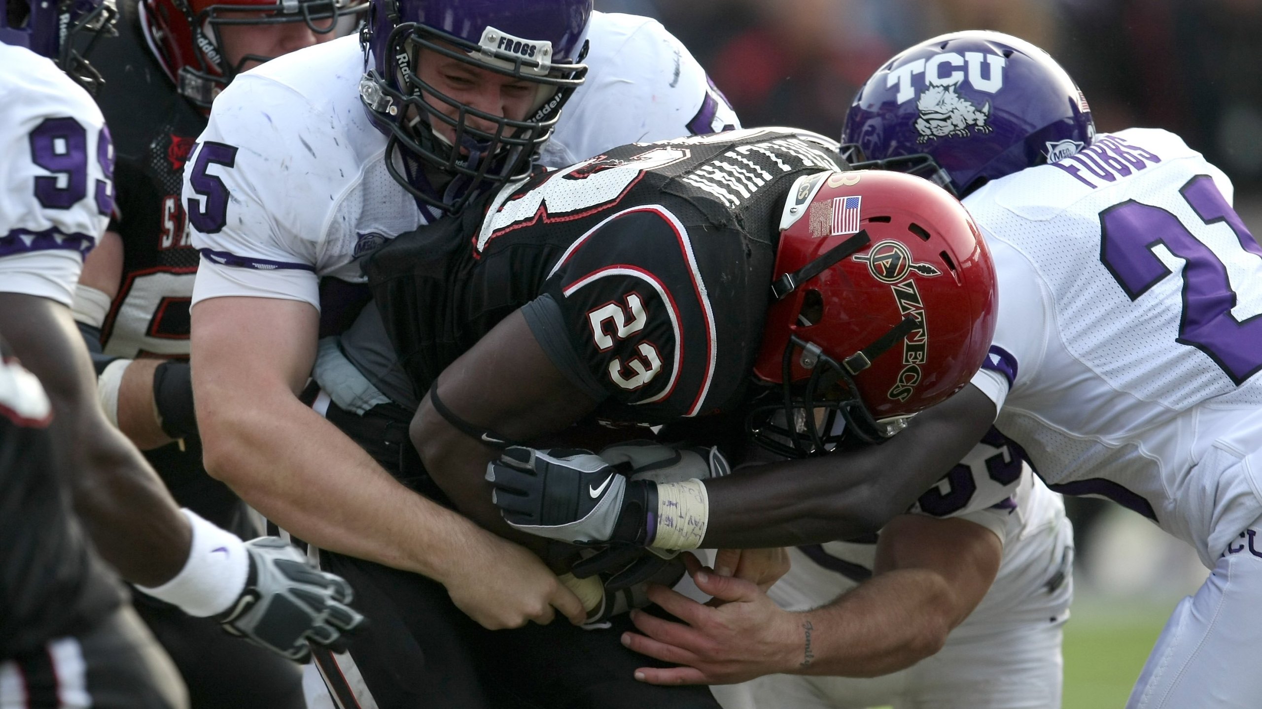 Defensive lineman D.J. Yendrey #55 of the Texas Christian University Horned Frogs tackles running back Brandon Sullivan #23 of the San Diego State Aztecs on November 7, 2009, at Qualcomm Stadium in San Diego, California. (Stephen Dunn/Getty Images)