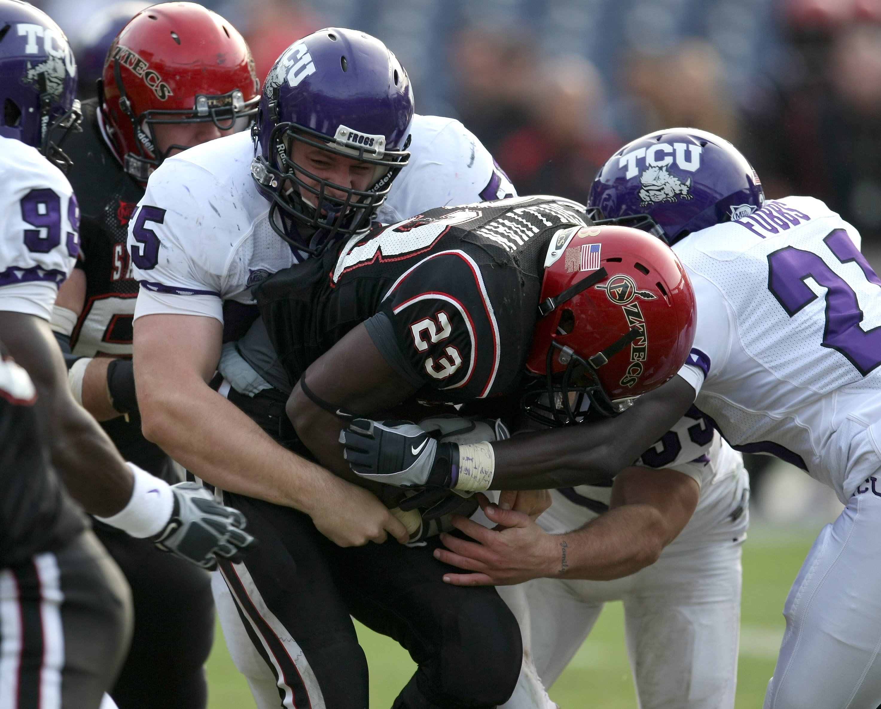 Defensive lineman D.J. Yendrey #55 of the Texas Christian University Horned Frogs tackles running back Brandon Sullivan #23 of the San Diego State Aztecs on November 7, 2009, at Qualcomm Stadium in San Diego, California. (Stephen Dunn/Getty Images)