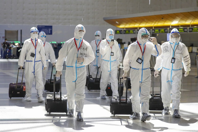 An airline flight crew wears protective gear at Los Angeles International Airport.(Irfan Khan / Los Angeles Times)