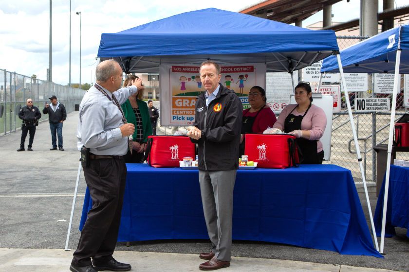 L.A. Schools Supt. Austin Beutner, center, tours a grab-and-go food center at John Liechty Middle School in downtown Los Angeles.(Gabriella Angotti-Jones / Los Angeles Times)