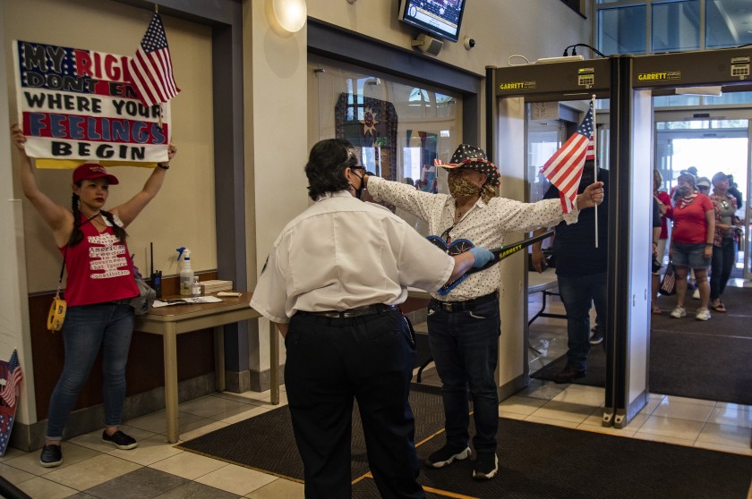 Protesters enter the County Administrative Center for a Riverside County Board of Supervisors meeting in May 2020. (Gina Ferazzi/Los Angeles Times)