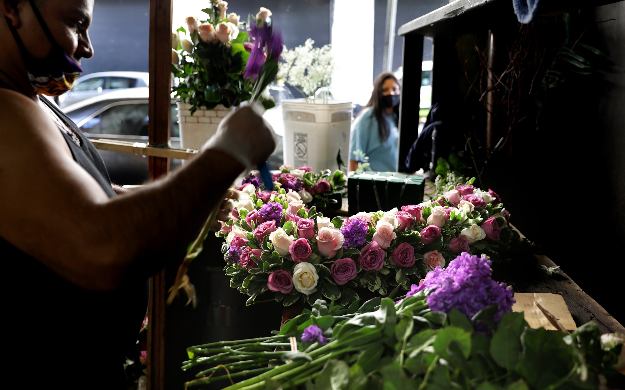 Jaime Miranda creates an arrangement at Lupita’s Flowers in downtown Los Angeles ahead of Mother’s Day weekend.(Christina House / Los Angeles Times)