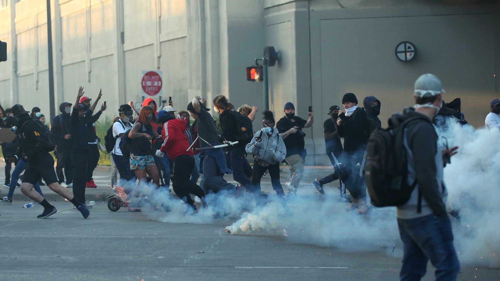 People run as tear gas canisters land near them during a protest sparked by the death of George Floyd while he was in police custody on May 29, 2020 in Minneapolis, Minnesota. (Scott Olson/Getty Images)