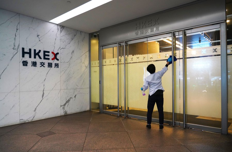 A cleaner disinfects a door of HKEX (Hong Kong Stock Exchange) Connect Hall on March 27, 2020 in Hong Kong, China. (Zhang Wei/China News Service via Getty Images)