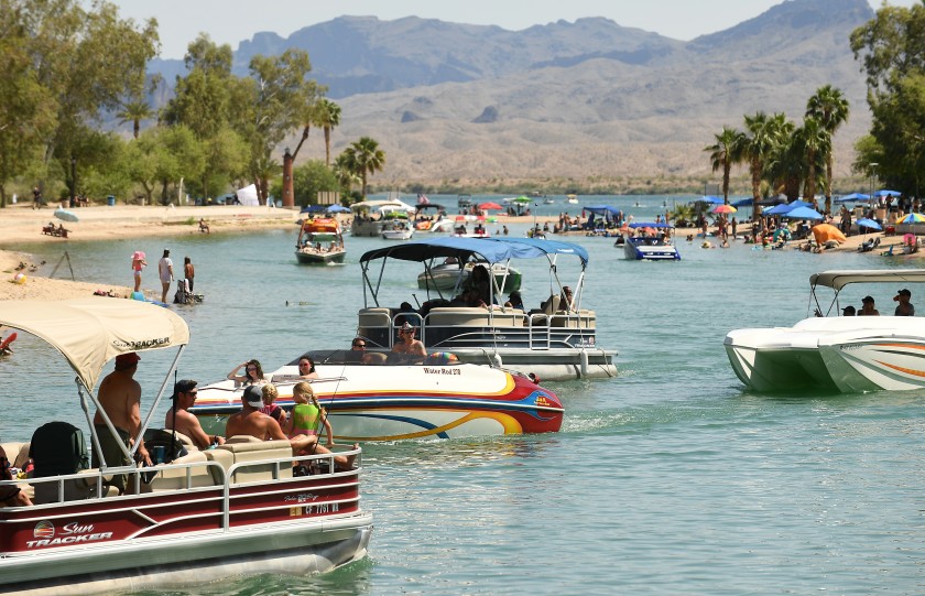 Boats pass through a channel in Lake Havasu City, Ariz., on May 9. The city has been crowded by an influx of Californians over the last few weekends.(Wally Skalij / Los Angeles Times)