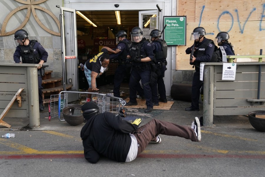 Protesters are thrown out of a Whole Foods Market in the Fairfax District of Los Angeles on May 30, 2020. (Kent Nishimura/Los Angeles Times)