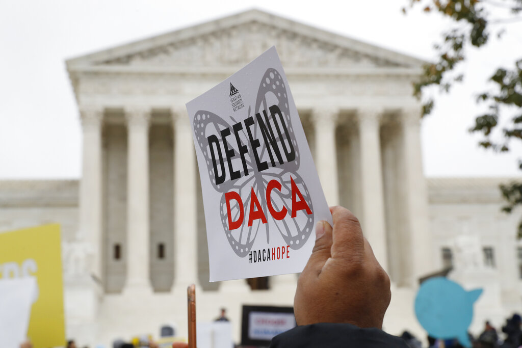 In this Nov. 12, 2019, file photo people rally outside the Supreme Court as oral arguments are heard in the case of President Trump's decision to end the Obama-era, Deferred Action for Childhood Arrivals program (DACA), at the Supreme Court in Washington. (AP Photo/Jacquelyn Martin, File)