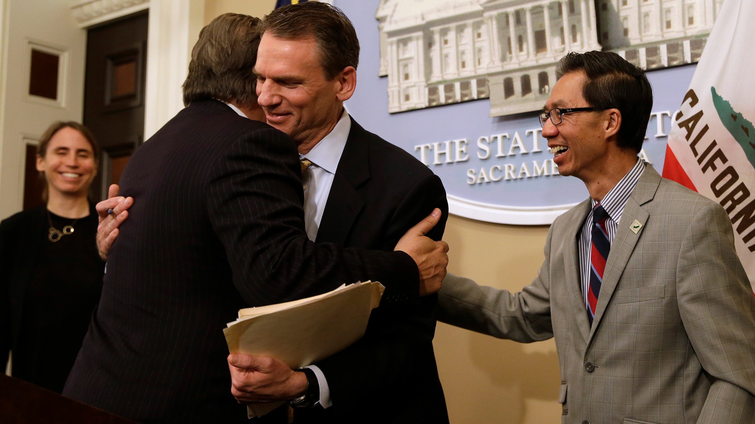 In this June 28, 2018, file photo, state Sen. Bob Hertzberg, D-Van Nuys, left, and Assemblyman Ed Chau, D-Arcadia, right, celebrate with Alastair Mactaggart, center, after the Legislature approved their data privacy bill in Sacramento. (AP / Rich Pedroncelli)