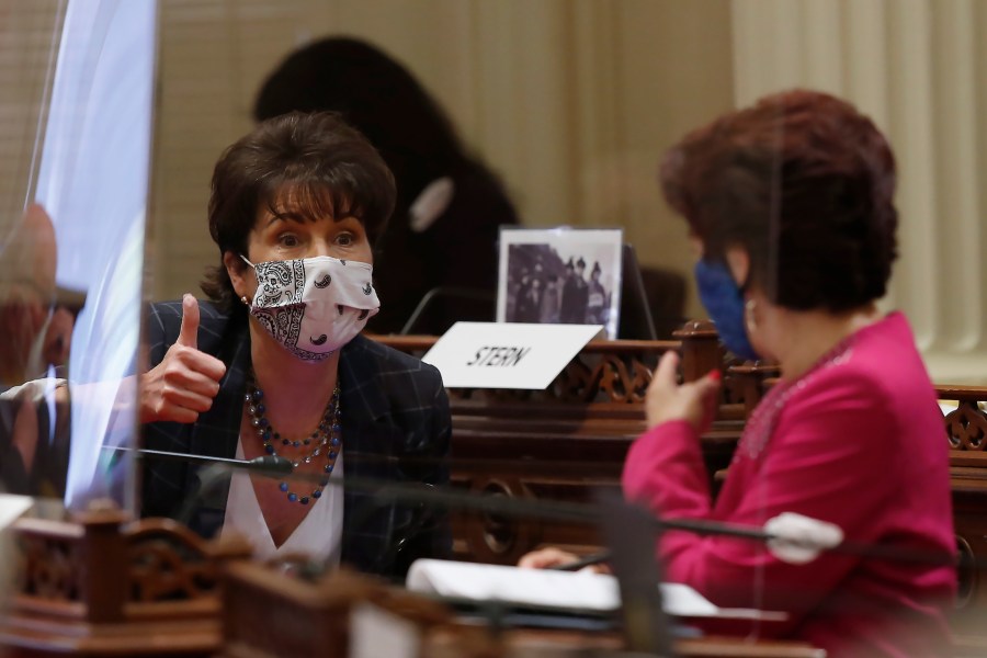 State Sen. Connie Leyva, D-Chino, left, gives a thumbs up as she talks with Sen. Anna Caballero, D-Salinas, at the Capitol, in Sacramento on June 25, 2020. (AP Photo/Rich Pedroncelli)